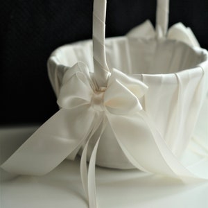 Ivory flower girl basket with large satin bow and hanging ribbon handle