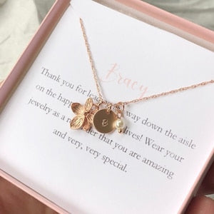 Rose gold tone necklace with flower charm and small round pendant