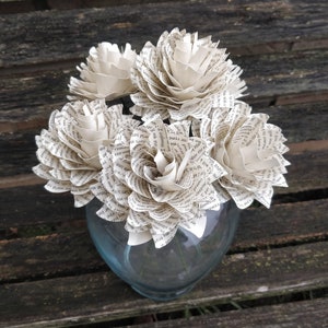 White flower bouquet with layered blooms in clear glass vase