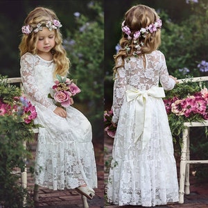 White long-sleeve lace flower girl dress with ribbon bow and floral headband