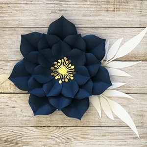 Dark blue paper flower with gold center and white petal accents
