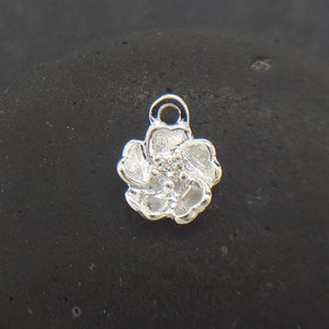 Sterling silver tiny flower charm with small loop bail at top