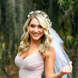 White flower crown with sheer veil, small blossoms and green leaves for bridal headpiece