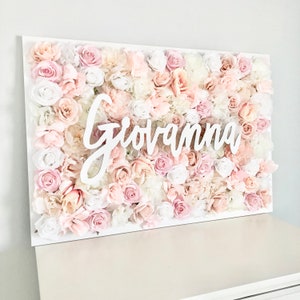 Floral name wall sign with cursive "Giovanna" over pink and white roses