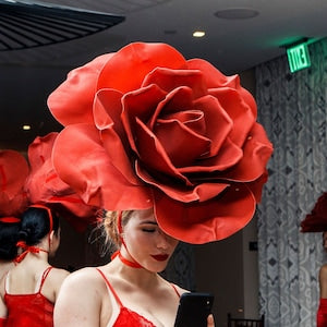 Large red rose headpiece worn on head, tiered petals, fabric flower fascinator