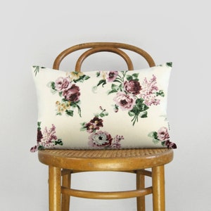 Floral pillow case with cream background and pink, burgundy, and yellow flowers