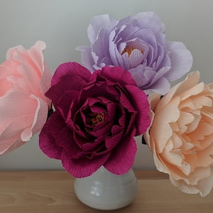 Crepe paper peony flowers, burgundy and pastel, in a white vase
