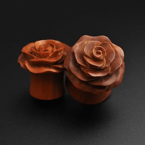 Brown organic wood double-flare plug with carved rose bud design