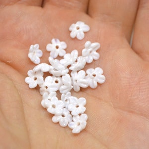 Mini flower bead applique with small white opaque blossoms and round bead centers