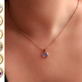 Rose gold flower necklace with small blue pressed-flower resin pendant on a delicate chain