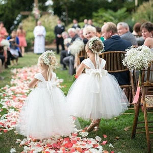 Ivory tulle flower girl dress with layered skirt and ribbon bow details