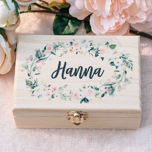 Wooden gift box with hinged lid, floral border and name Hanna on the front.