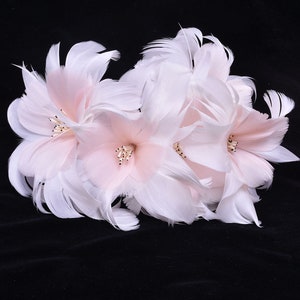 White feather flower trim with soft pink center accents and layered petals