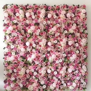 Artificial flower wall panel with dense pink and white faux blooms and green leaves