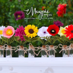 Mini felt flower bunch with sunflower, poppy, daisy-style blooms and green leaves