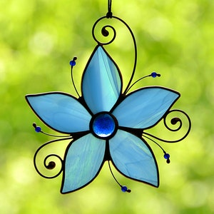 Blue stained glass flower suncatcher with black hanging loop and swirl design