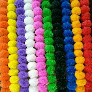 Artificial pom-pom flower garland strings in multicolor rows (yellow, purple, pink, green, blue)