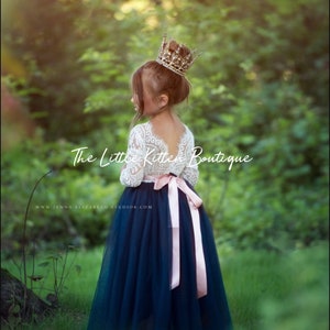 Navy blue flower girl dress with lace bodice, tulle skirt, and bow accents