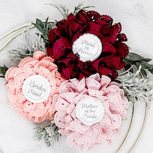 Floral name tag pin set with red and pink fabric flowers and round badges