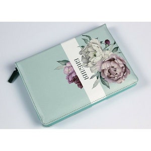 Turquoise softcover Bible with floral panel and buckle closure