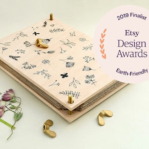 Wooden flower press with botanical patterned paper insert and brass corner clamps