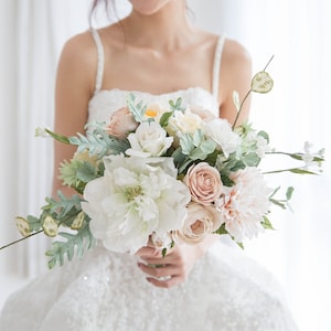Paper bridal bouquet with white, blush, and pastel flowers and green leaves