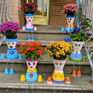 Colorful metal flower pot people planters, face-shaped figures holding flower pots