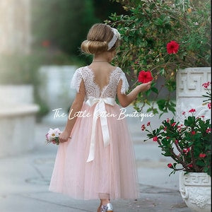 Blush tulle flower girl dress with lace back and bow detail