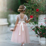 Blush tulle flower girl dress with lace back and bow detail