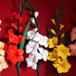 Gladiolus-style paper flower stems in red, yellow, and white with green leaves