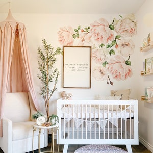 Pink rose floral wall decals with leaves above a nursery crib