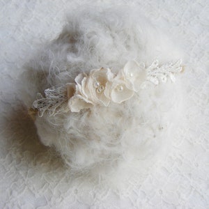 Newborn headband with white lace ruffle and small floral tieback detail