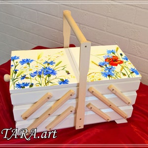 Accordion storage box with blue field flower pattern, white body and wooden dividers