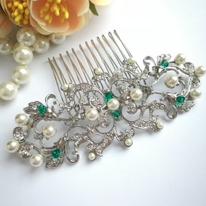 Silver hair comb with emerald green crystals, pearls, and ornate floral filigree