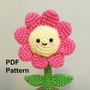 Crochet amigurumi potted flower pattern: pink flower with yellow face, green stem and pot