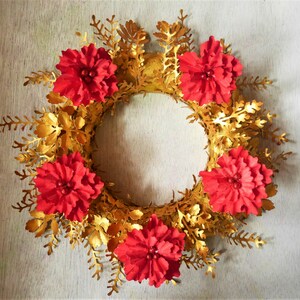 Red and gold floral wreath with pine leaves and looped center flowers