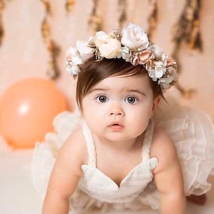 Baby flower crown with white and beige blooms on head, halo style