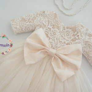 Ivory toddler flower girl dress with lace long sleeves and large tulle bow waist