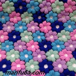 Crochet blanket with puff-flower pattern in blue, pink, purple, and mint