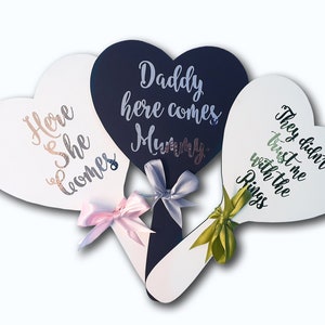 Heart-shaped wedding paddle sign, dark navy cursive text with bow and small flowers