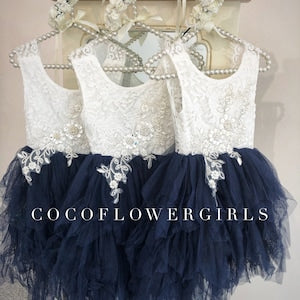 Navy blue flower girl dress with white lace bodice and ruffled tulle skirt