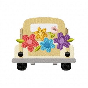 Yellow flower embroidery design on a beige pickup truck front with multicolor blooms