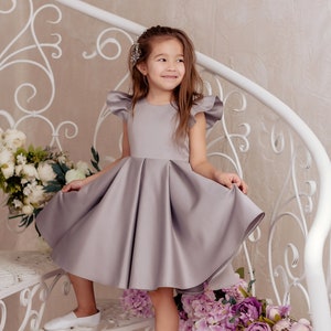 Gray satin flower girl dress with cap sleeves and full gathered skirt