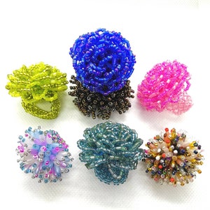 Colorful beaded flower cluster rings with pom-pom beads and elastic bands