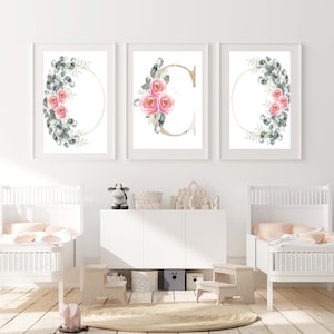 Set of three floral nursery wall art prints in white frames with pastel flowers