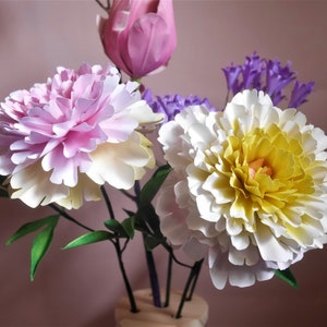 Peony flower bouquet with white, pink, and yellow blooms, purple accent flowers
