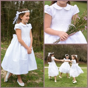 White flower girl dress with smocked bodice, short sleeves, and matching headband