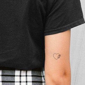 Minimalist heart and flower temporary tattoo on forearm, fine line black ink