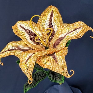 Gold bead embroidered flower applique with green leaf accents
