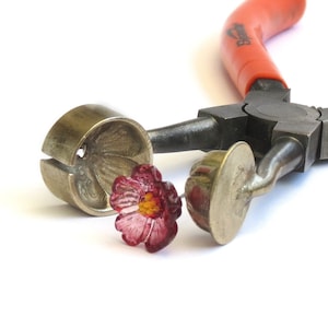 Lampwork tool with metal mashers and small red flower lampwork pieces